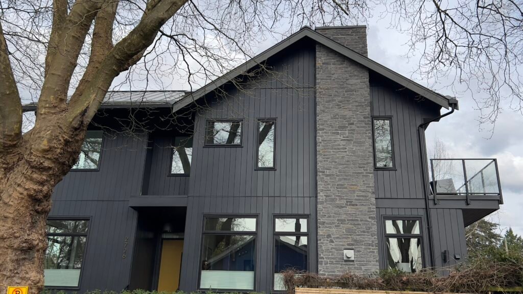 Completed exterior siding project combining stone veneer and James Hardie panels