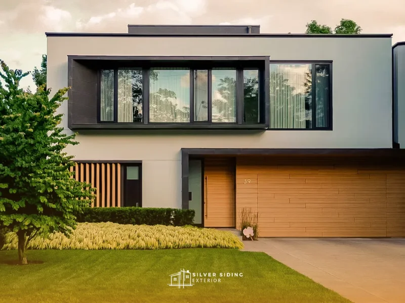 modern home exterior with horizontal wood-look siding and dark panel accents