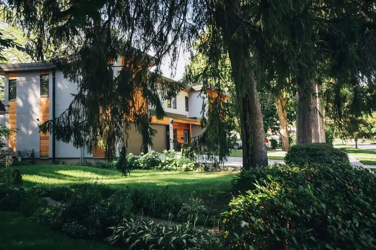Modern home with cedar and stucco exterior siding surrounded by trees in North Vancouver